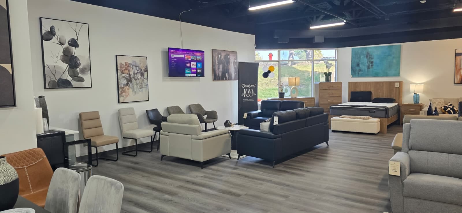 Chairs, a sofa, and a bedroom set on display in the Rockwell Home showroom