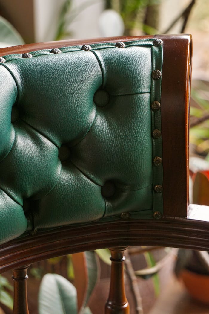 Crafting Captivating Headlines: Your awesome post title goes here Close-up of a green leather and wooden chair, highlighting detailed upholstery.