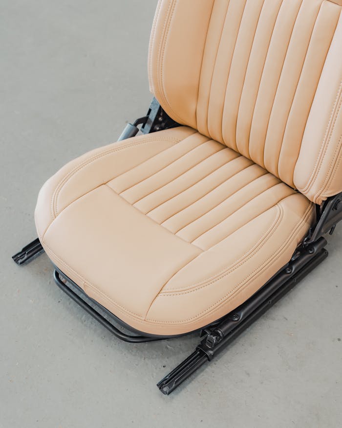 Mastering the First Impression: Your intriguing post title goes here High-quality beige leather car seat with detailed stitching, perfect for modern interior design and automotive enthusiasts.